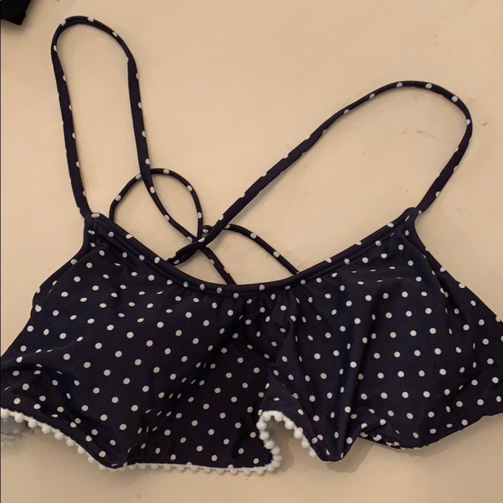 Navy blue and white polka dot ruffle bikini top.
